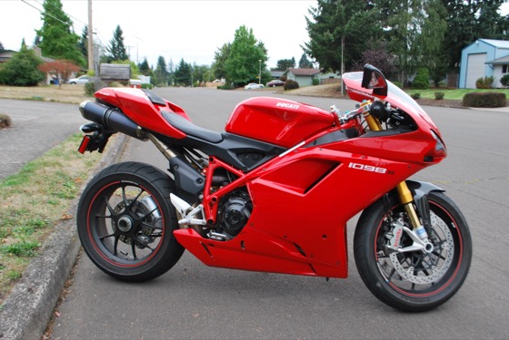 A red 2008 Ducati 1098 S parked on a suburban street, side view