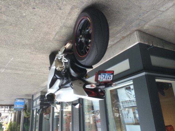 A white 2013 Ducati 1199 S parked on a sidewalk in Pioneer Square, Seattle