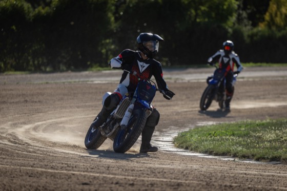 Jonathan sliding a flat track bike, foot out, at Valentino Rossi's Motor Ranch in Italy