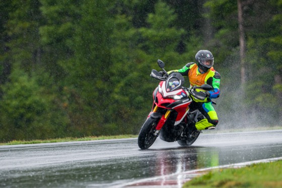 Jonathan riding the Multistrada through pouring rain on track