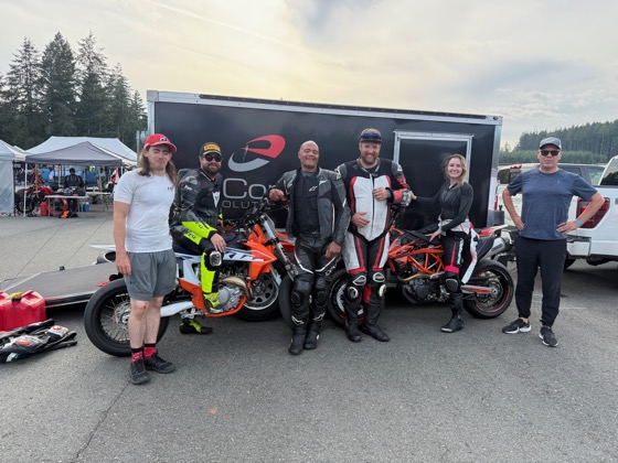 The enCompass B Team with the KTM 450 SMR in front of the team trailer