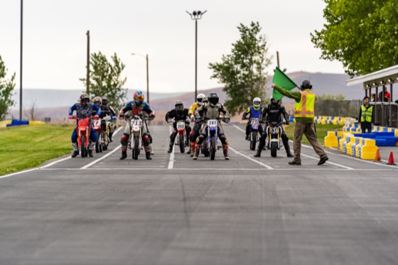 Riders lined up on the grid for the restart as the flagger raises the green flag (photo 37 of 77)