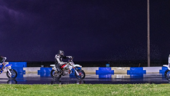Jonathan Spiva on the #711, reflected in the wet track under a storm sky (photo 68 of 77)