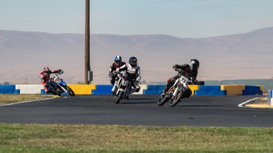 Riders spread through a corner with the hills behind (photo 20 of 117)