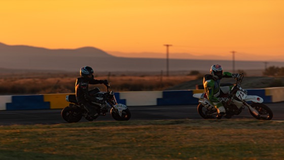 Two riders silhouetted against the sunset, the #711 among them (photo 54 of 117)