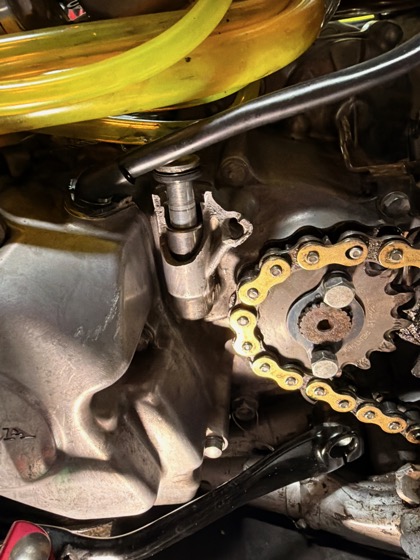 Close-up of the Honda CRF150R engine case repaired with JB Weld