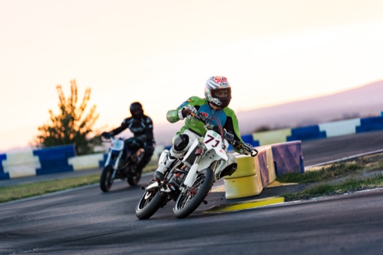 John Gessner on the #711 leading another rider through a corner at sunset (photo 61 of 117)