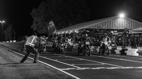 Black and white: the flagger restarting the field at night (photo 69 of 117)