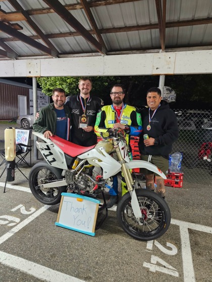 The Spiva Racing Team with their medals and the Honda CRF150R #711