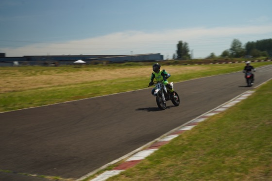 Jonathan Spiva (#711) at speed on the Honda CRF150R down a straight at Mac Track