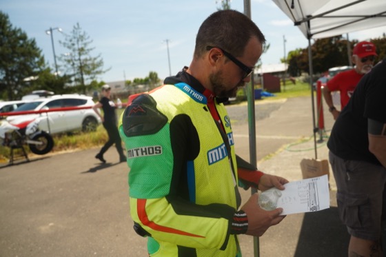 Jonathan Spiva studying a printed timing sheet in the paddock