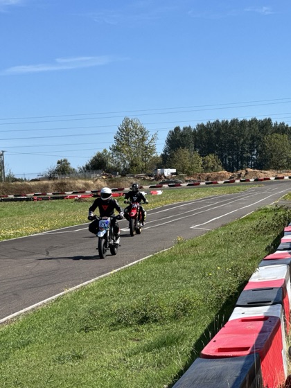 Jonathan Spiva (#711) on the Ducati Desmo450 following Greg Kearns (#206) down the straight at Mac Track (photo 6 of 7)