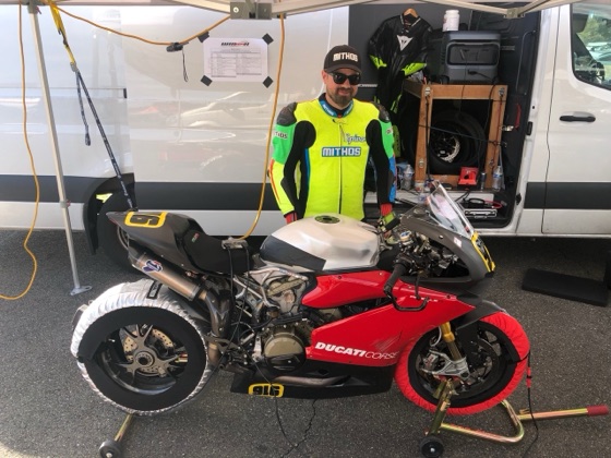 Jonathan Spiva beside the #916 Ducati Panigale R in the paddock