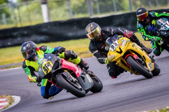 Jonathan Spiva (#916) battling two riders at PIR