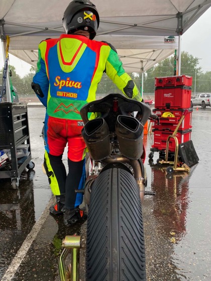 Jonathan Spiva in the wet PIR paddock beside the #916 Ducati