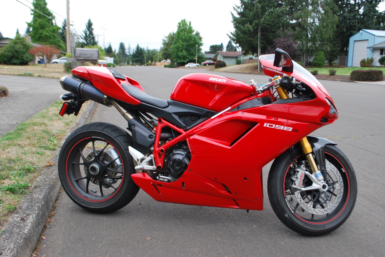 A red 2008 Ducati 1098 S parked on a suburban street, side view