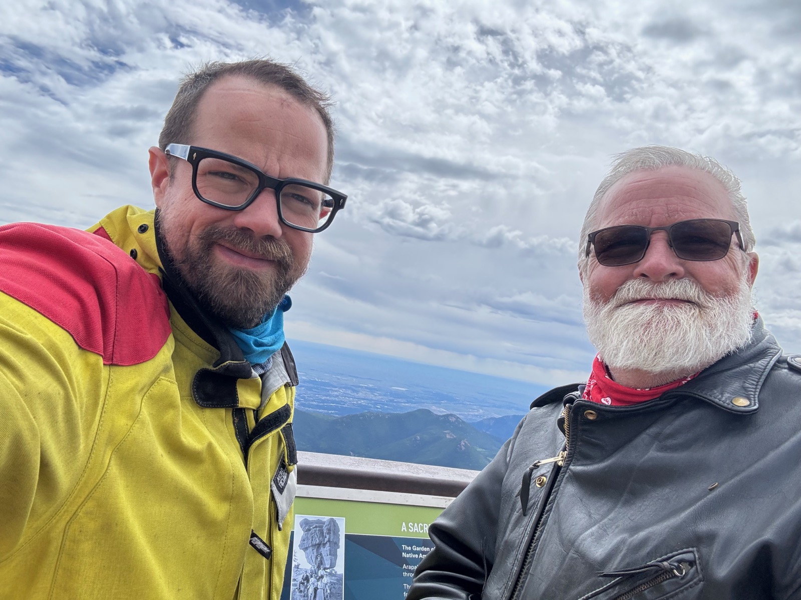 Selfie at a mountain summit overlook partway through a motorcycle trip