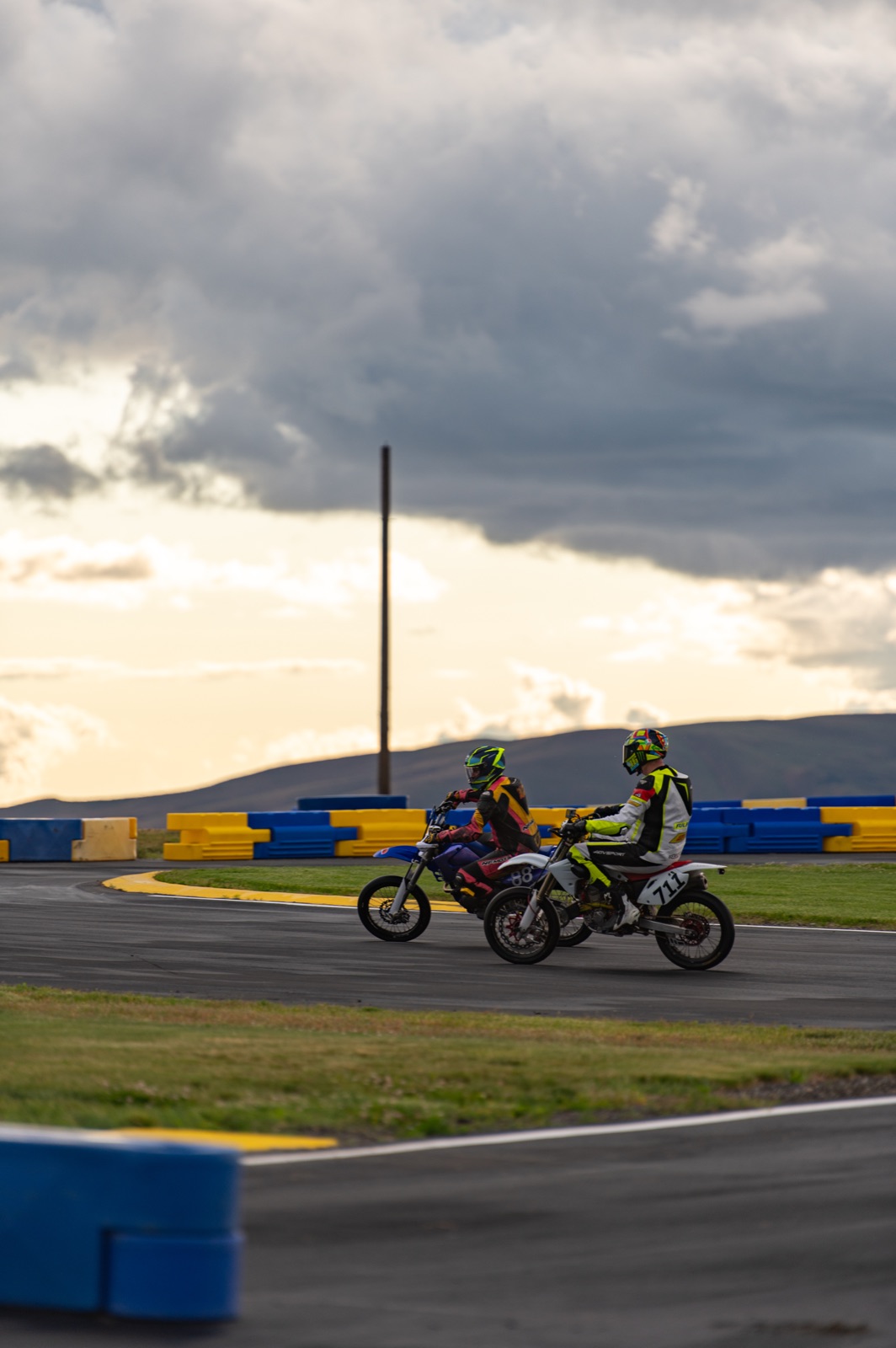 The #711 alongside a blue bike under a stormy sky (photo 57 of 77)