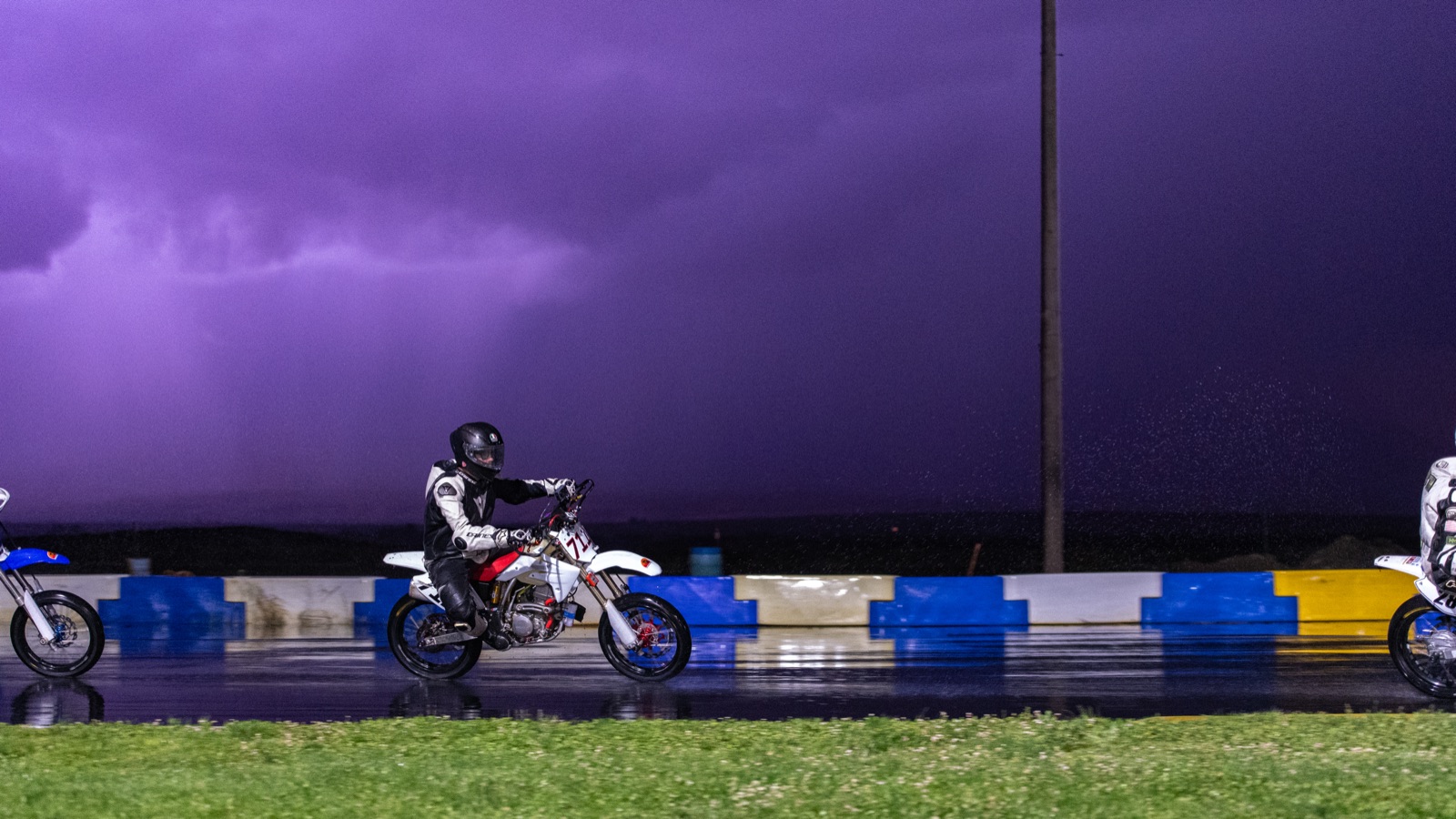 Jonathan Spiva on the #711 on a wet track under a purple storm sky (photo 67 of 77)