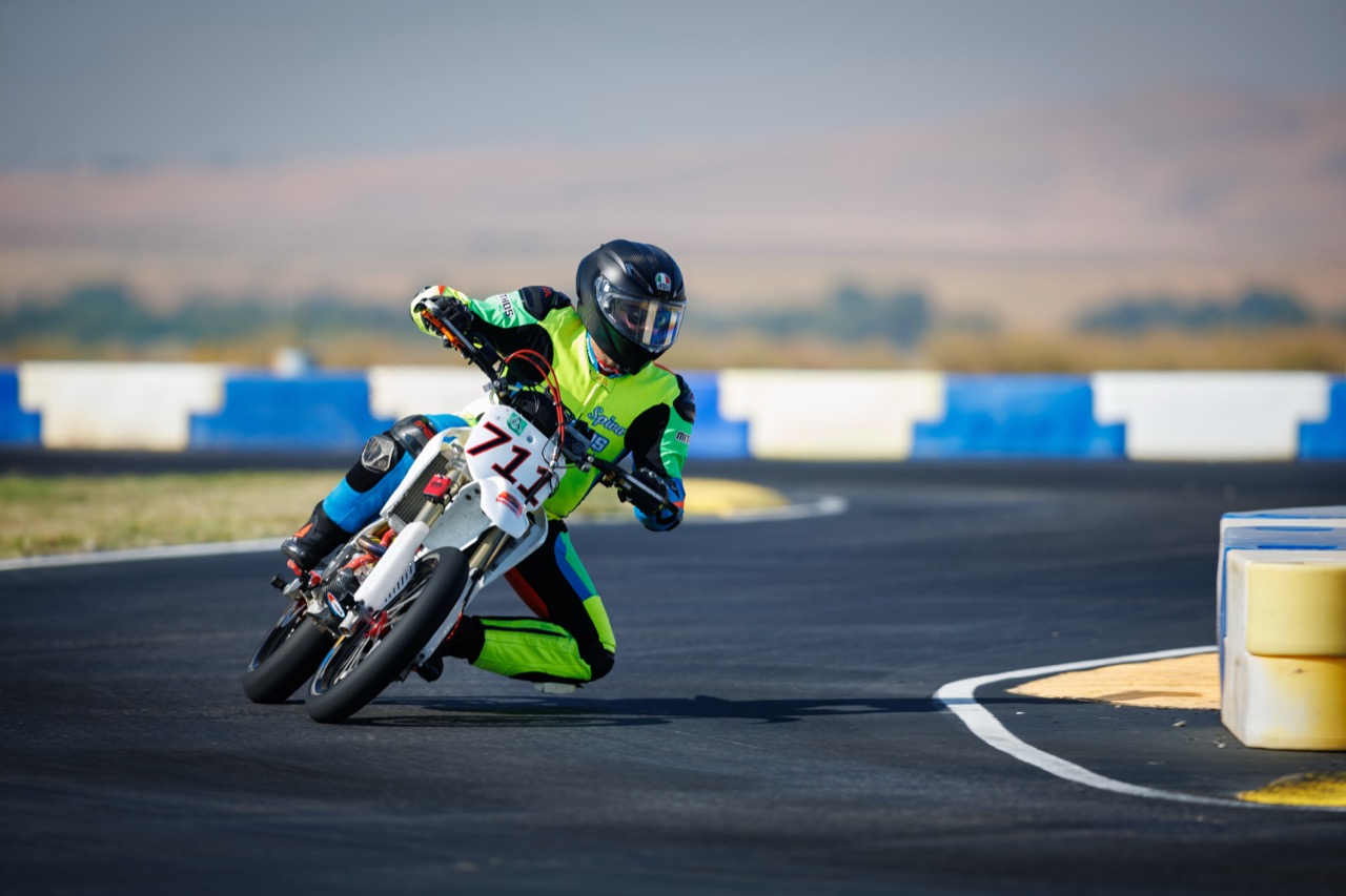 Jonathan Spiva (#711) hard into a corner on the Honda CRF150R