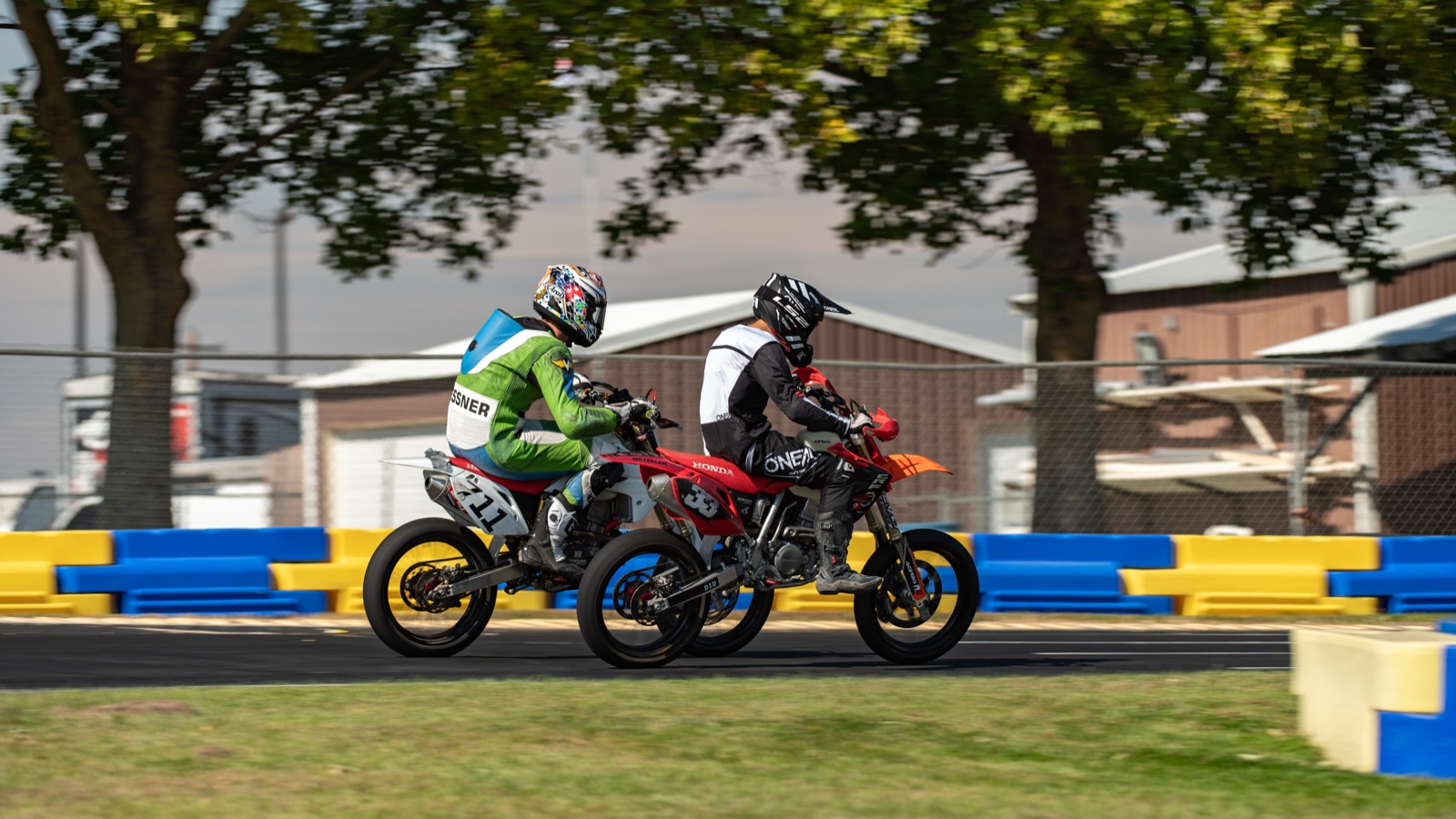 John Gessner on the #711 alongside a red bike under the trees (photo 26 of 117)