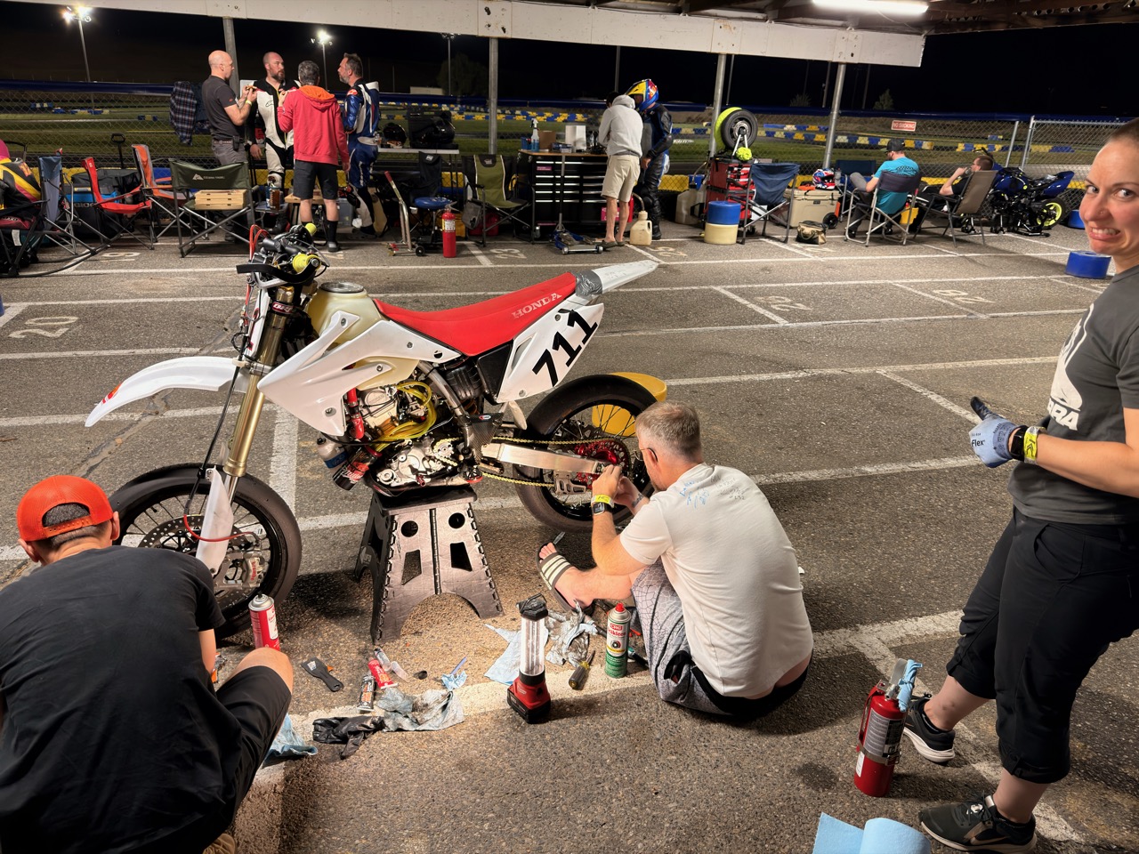 The Spiva Racing Team working on the #711 in the pits at night
