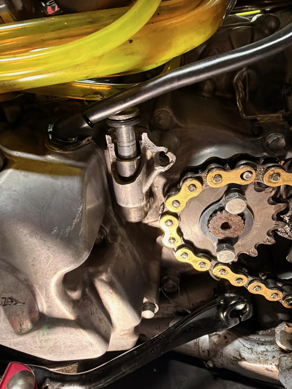 Close-up of the Honda CRF150R engine case repaired with JB Weld