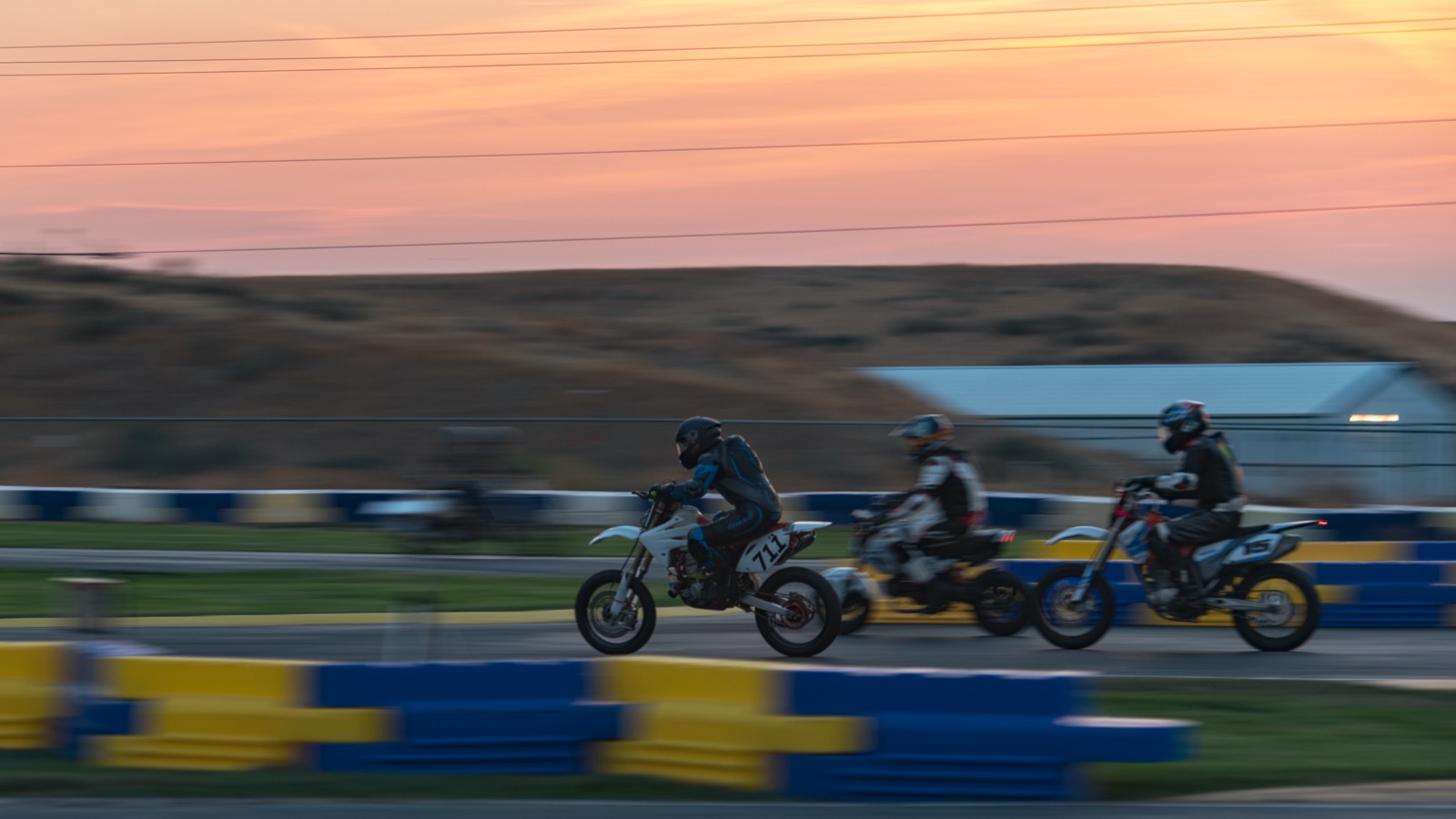 Panning shot of three riders at sunrise, the #711 among them (photo 80 of 117)