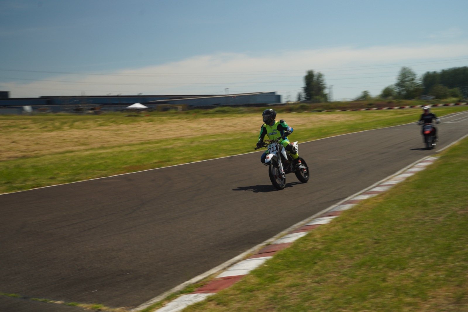 Jonathan Spiva (#711) at speed on the Honda CRF150R down a straight at Mac Track