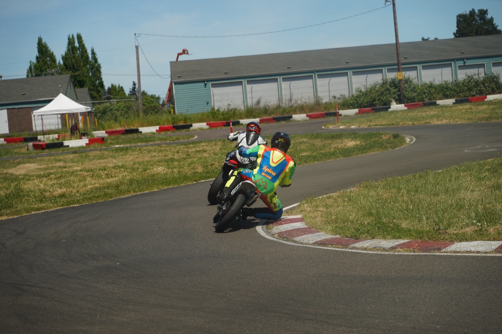 Jonathan Spiva (#711) cornering the Honda CRF150R foot-out at Mac Track, chasing another rider