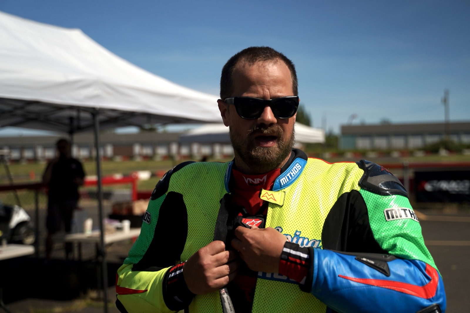 Jonathan Spiva in the paddock in Spiva Mithos leathers, helmet under his arm