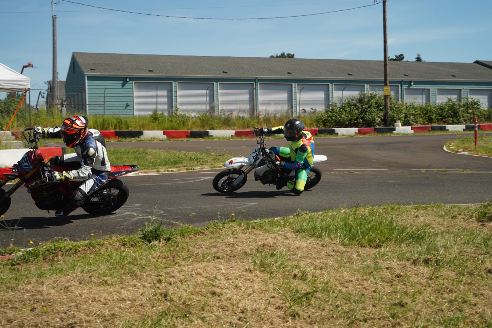 Two riders leaned into a corner, Jonathan Spiva chasing the leader at Mac Track