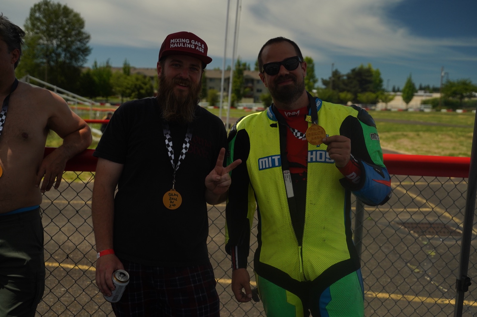 Jonathan Spiva holding a medal alongside a friend after the round