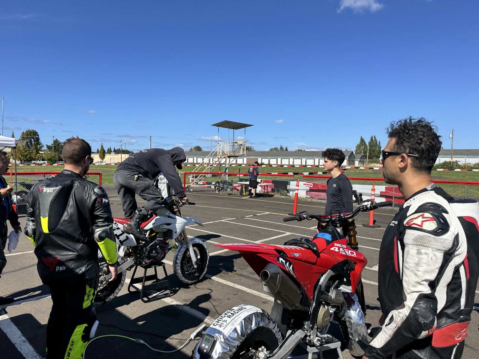 The Honda CRF150R (#711) being kick-started in the Mac Track paddock, Jonathan Spiva standing by (photo 3 of 7)