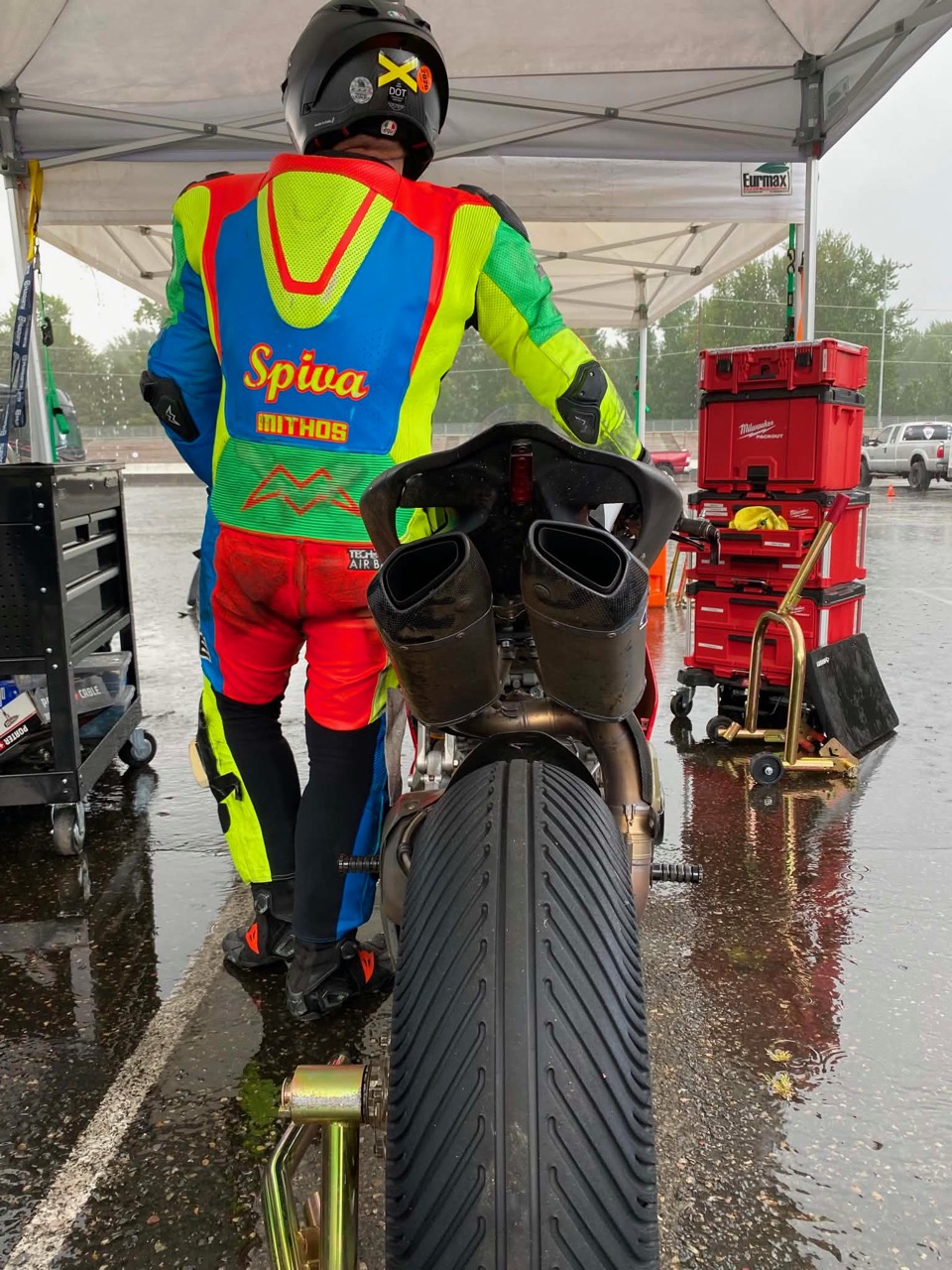 Jonathan Spiva in the wet PIR paddock beside the #916 Ducati