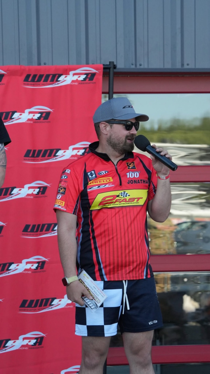Jonathan Spiva speaking at the Round 4 podium