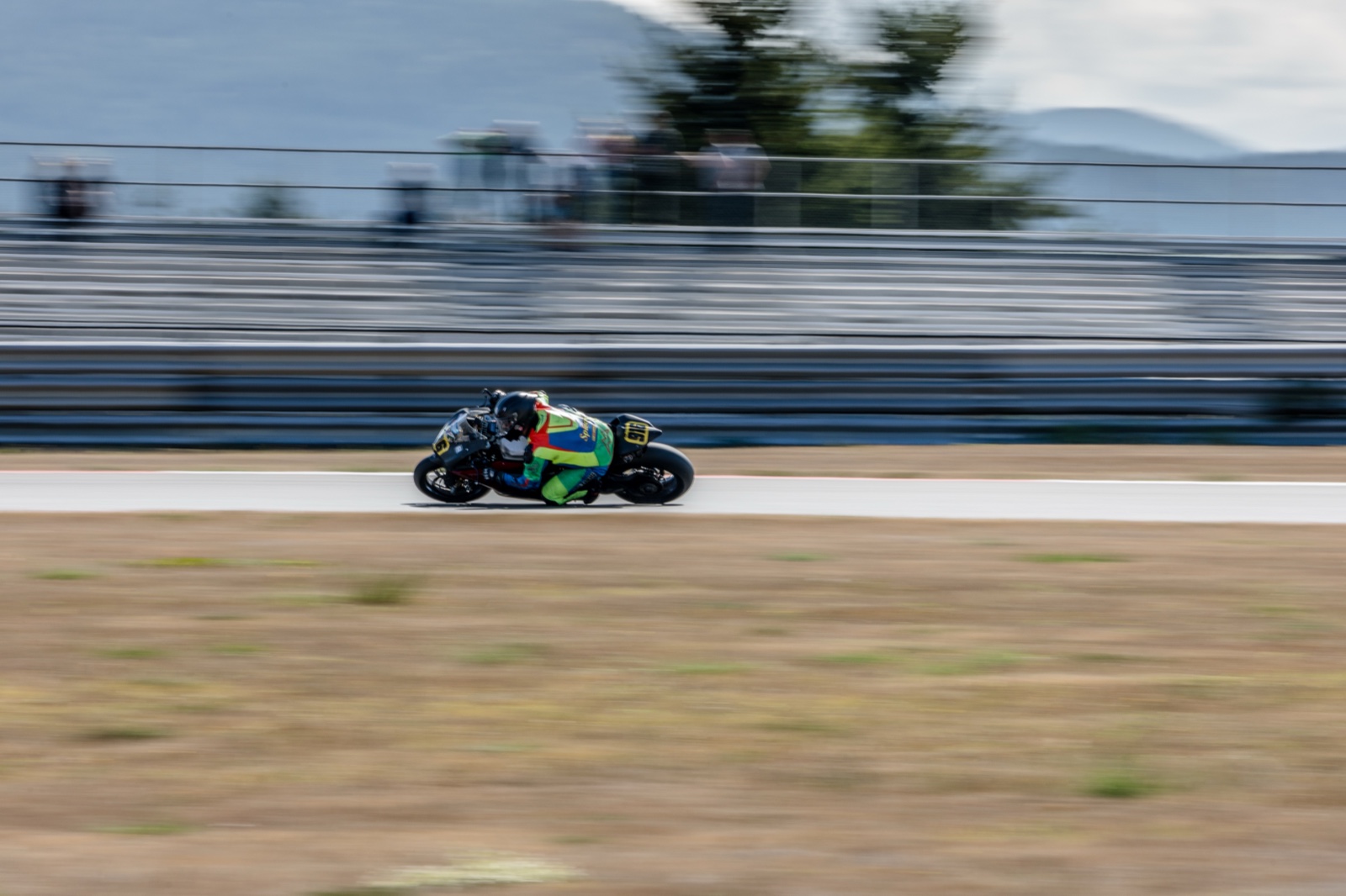 Jonathan Spiva (#916) at full lean on the Ducati Panigale R past the grandstand at The Ridge Motorsports Park